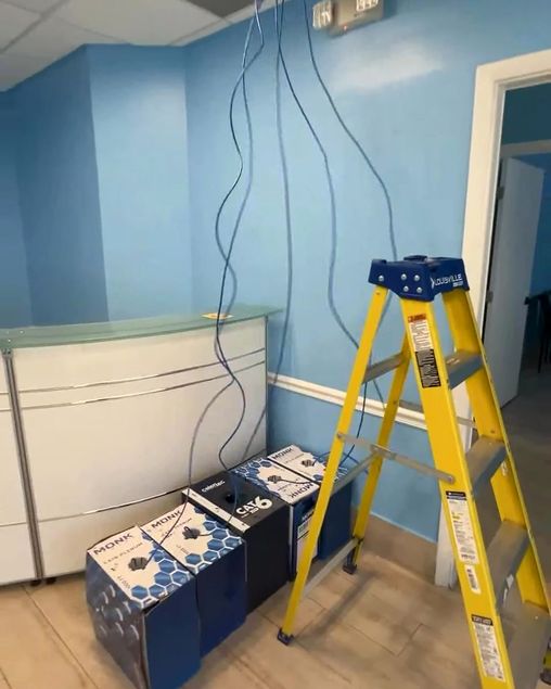 Cat6 network cables coming down from the ceiling during a from-scratch clinic install