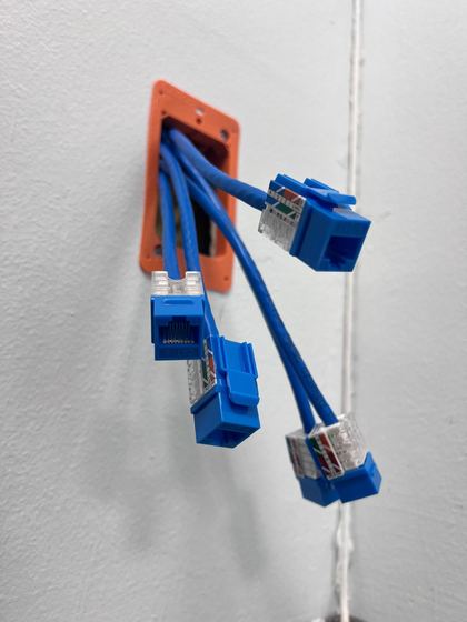 Cat6 cables with keystone jacks coming out of a wall box
