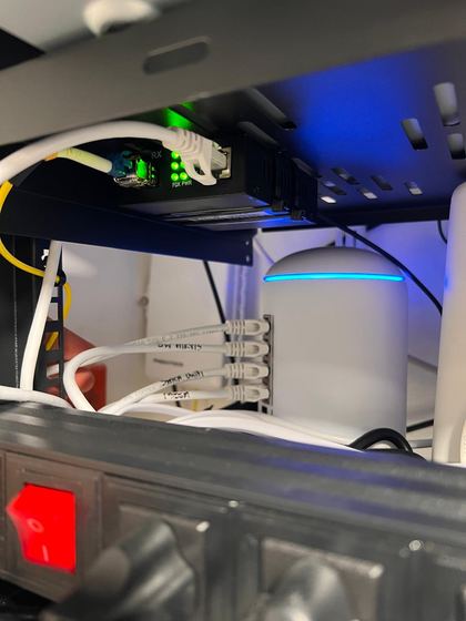 Fiber media converter and UniFi router connected in a rack