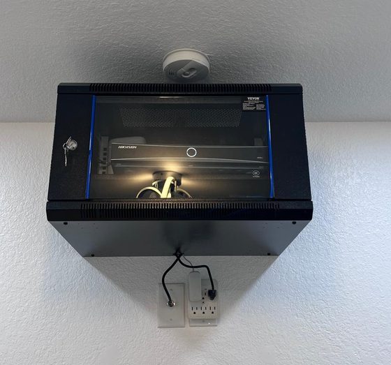 Locking wall cabinet with a Hikvision camera recorder installed