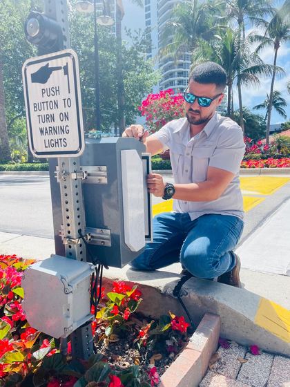 Héctor Travieso, founder of HT Tech Solutions, working on the control box of a warning light system
