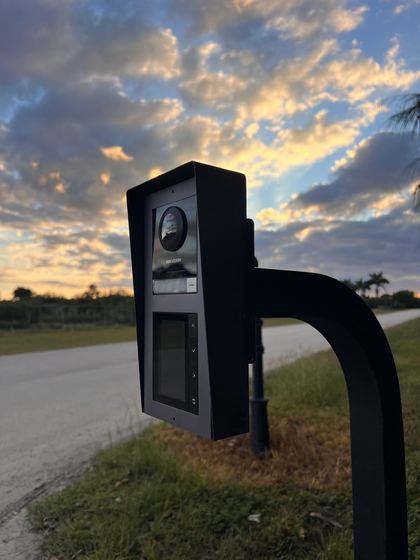 Hikvision intercom with directory screen on a post by the road
