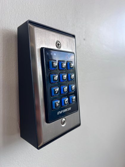 Code keypad with card reader to open a door